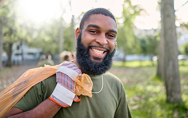 Image showing Plastic bag, park and black man cleaning for earth day, eco friendly or community service in volunteering portrait. Recycle, trash or garbage of happy ngo person in nature or forest for pollution