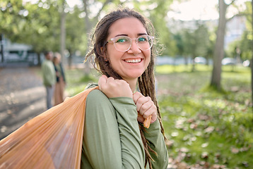 Image showing Plastic bag, park and happy woman for eco friendly cleaning on earth day, community service or volunteering support. Recycle, trash or garbage of ngo person in portrait for nature or forest pollution