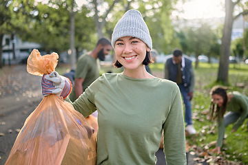 Image showing Park, plastic bag and woman in cleaning portrait for eco friendly environment, community service or volunteering. Recycle, trash or waste goals of happy ngo person in nature, forest pollution support