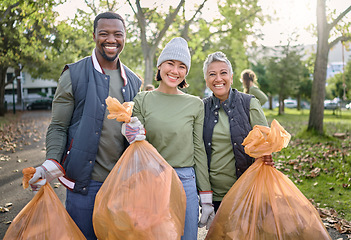 Image showing Volunteer men and women cleaning park as community service with plastic in garbage bag. Diversity group help with trash for eco friendly lifestyle and bottle recycling for pollution outdoor in nature