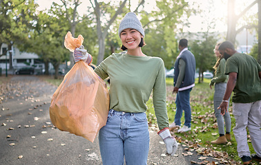 Image showing Plastic bag, park and happy woman in cleaning portrait for earth day, community service or volunteering support. Recycle, trash or garbage goals of ngo person helping in nature or forest pollution