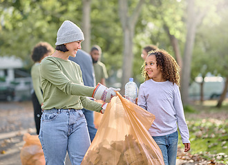 Image showing Volunteer, child and woman cleaning plastic in park with garbage bag for a clean environment. People learning and helping with trash for eco friendly, community service and recycling bottle in nature