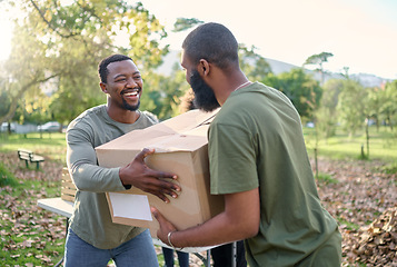 Image showing Black man, charity and holding box in park of donation, community service or social responsibility. Happy guy, NGO workers and team helping with package for volunteering, support and society outreach