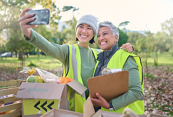Image showing Selfie, volunteer and donation with a woman charity or relief worker friends taking a picture together. Teamwork, community and photograph with female people carrying a box for humanitarian aid