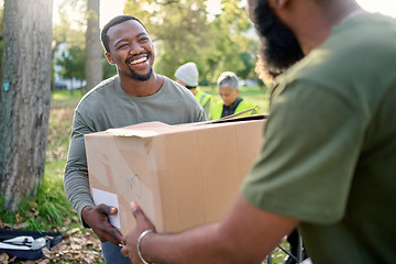 Image showing Black man, volunteering and giving box in park of donation, community service or social responsibility. Happy guy, NGO worker and helping with package outdoor for charity, support or society outreach