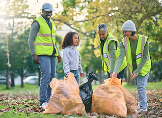 Image showing Child with volunteer group for cleaning park with garbage bag for a clean environment. Men, women and child team helping and learning eco friendly lifestyle, community service and recycling in nature