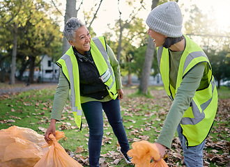 Image showing Volunteer, happy women and community service while cleaning park with garbage bag for a clean environment. Team helping with trash for eco friendly lifestyle, ecology and recycling outdoor in nature