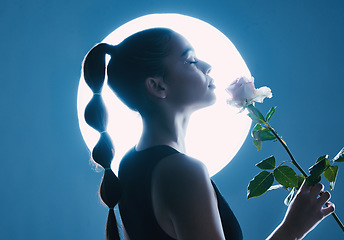 Image showing Circle light, art and woman in studio on blue background with flower for dark beauty aesthetic, magic and fantasy. Night, futuristic or creative model person with white rose on moon spotlight mockup