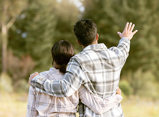 Image showing Trees, nature gesture and couple hug on outdoor quality time together, hiking adventure or forest bonding journey. Peace, freedom and love for back of travel woman, man or people trekking in woods