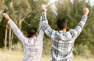 Image showing Behind, hiking and couple holding hands for success in forest for achievement, victory or fitness goals. Travel, freedom and man with woman celebrating milestone, journey and adventure goal in nature