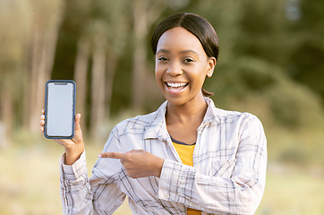 Image showing Mockup phone screen, smile and portrait black woman pointing at marketing or advertising content. Outdoor, technology and person point with happiness and online on mobile with blurred background