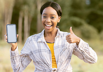 Image showing Black woman, phone and thumbs up for winning on mockup display or screen for discount or sale in nature. Portrait of happy African American female smiling for giveaway prize, deal or 5G smartphone