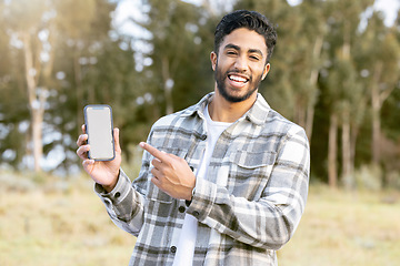 Image showing Mockup, phone and portrait of man in nature or forest with mobile app, product placement or 5g technology promotion. Happy person, hand holding smartphone and space, mock up and screen in a park