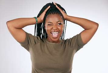 Image showing Comic, funny and black woman with a crazy face isolated on a grey studio background. Smile, happy and African girl model with tongue sticking out for comedy, happiness and goofy on a backdrop