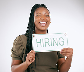 Image showing Creative business woman, hiring sign and advertisement for recruiting isolated on gray studio background. Portrait of happy African American female manager with board for recruitment, hire or startup