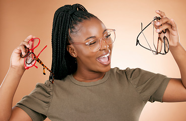 Image showing Excited, glasses frame choice and black woman with a smile from eye care and retail product. Studio background, isolated and beauty of a young student feeling happiness about vision product shopping