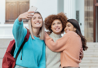 Image showing Women students, selfie and smile with hug at college campus for goals, diversity and social network. Gen z woman, group and smartphone with embrace, happiness and studying at university for success