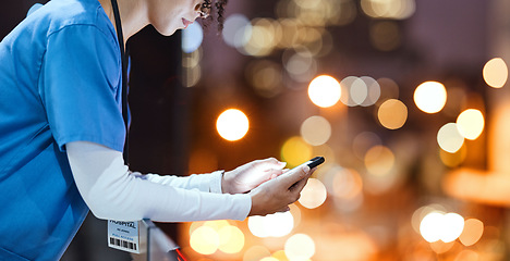 Image showing Night, doctor and hands of woman texting in a city, relax and break outdoors against bokeh background. Female, mockup and young nurse with smartphone for app, planner and schedule, online and search