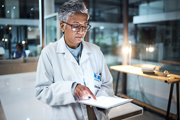 Image showing Doctor, tablet and senior woman in hospital working on telehealth, research or online consultation. Medical, healthcare or elderly female physician with technology for wellness app in clinic at night