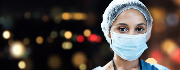 Image showing Woman, doctor and portrait with face mask with space in night, hospital workplace or career vision in surgery. Healthcare expert, dark clinic mockup or focus goal with ppe safety, surgeon and hairnet