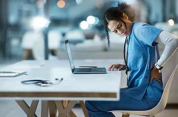 Image showing Back pain, stress and doctor in her office at the hospital working on a diagnosis or cure. Computer, healthcare and female medical worker with a muscle sprain, ache or inflammation at medicare clinic