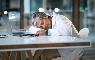 Image showing Woman doctor sleeping at desk in overtime medical office, late hospital and burnout. Stress, night and healthcare worker nap at table with fatigue, tired job and mental health problem from overworked