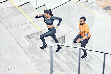 Image showing Fitness, above and running couple on stairs for training, health exercise and sports in city. Healthy, lifestyle and man and woman with focus, music and energy for outdoor cardio on steps in France