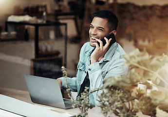 Image showing Creative man, phone call and laptop laughing at cafe for communication, social network or funny conversation. Happy male freelancer laugh for joke or startup on smartphone at coffee shop restaurant