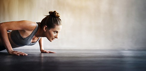 Image showing Woman, fitness and pushups on mockup for exercise, workout or intense training on floor. Sporty female lifting body off the ground with arm strength in motivation for healthy cardio or exercising