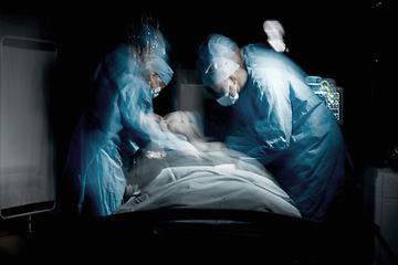 Image showing Healthcare, surgery and team of surgeons working on a patient for an emergency operation in the hospital. Medical, blur motion and group of doctors operating in a surgical room in the medicare clinic