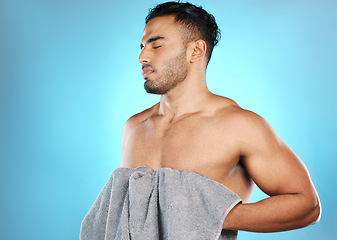 Image showing Skincare, man and clean with towel, cosmetics and wellness for body care on blue studio background. Male, gentleman and cloth for drying, natural beauty and hygiene grooming routine and treatment