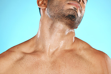 Image showing Skincare, neck and man with cosmetics for wellness, health and washing on blue studio background. Male, gentleman and wet shoulders for natural beauty, hygiene and cleaning for smooth and soft skin