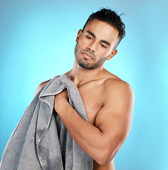 Image showing Shower, towel and man isolated on blue background for skincare, beauty and body wellness with mockup space. Washing, hygiene and cleaning model or young person in studio for dermatology or self care