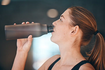 Image showing Fitness, break and woman athlete drinking water for thirst, hydration and health in a training studio. Sports, wellness and young female enjoying a healthy cold beverage after a workout or exercise.