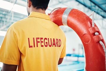 Image showing Lifeguard, man and swimming pool safety at indoor facility for training, swim and exercise. Pool, attendant and water sports worker watching for danger, protection or diving athletics, ready and safe