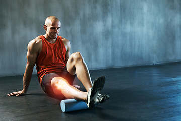 Image showing Stretching, fitness and man with a foam roller for muscle relief, training and care for body at gym. Sports, warm up and athlete with inflammation in legs, equipment for physical therapy and injury