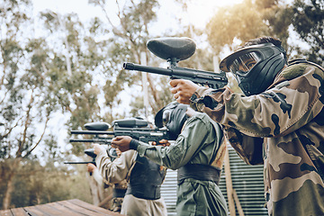 Image showing Team, paintball and shooting range for target practice in preparation for extreme sports match or game outdoors. Group of people, soldiers or army aiming to shoot by training bunker for competition