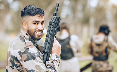 Image showing Paintball gun, man and portrait with smile, camouflage clothes and excited to start military combat game. Army training, warfare games and adventure for workout, shooting and challenge with friends