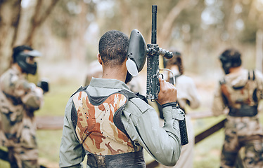 Image showing Paintball, gun and back of man in woods ready for games, arena match and shooting battle outdoors. Extreme sports, adventure and male with weapon in camouflage, military clothes and action gear