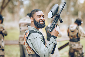 Image showing Sports, paintball and portrait of black man with gun ready for game, arena match and shooting battle outdoors. Smile, adventure and male with weapon in camouflage, military clothes and action gear