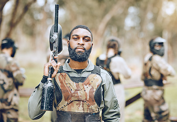 Image showing Paintball, gun and portrait of black man in park ready for games, match and shooting battle outdoors. Extreme sports, adventure and male in camouflage, military clothes and action gear for arena