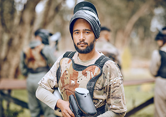 Image showing Paintball, sports and portrait of man with gun in woods ready for game, arena match and shooting battle. Training, adventure and male with weapon in camouflage, military clothes and action gear