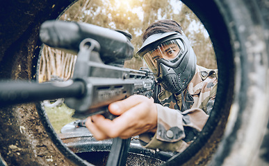 Image showing Paintball, gun and man with focus, safety uniform and extreme sports for activity, gear and competition. Teamwork, male player or guy with camouflage, shooting paint rifle or military weapon for game