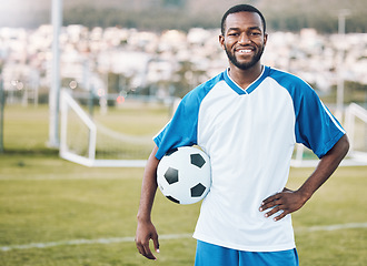 Image showing Sports, soccer and portrait of black man with ball and smile on face with motivation for winning game in Africa. Confident, proud and happy professional football player at exercise or training match.