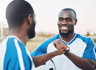 Image showing Fist bump, soccer athlete and man with teamwork success of sports training on a grass field. Football friends, support and exercise support with motivation outdoor for health workout and smile