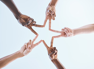 Image showing Below, hands and star, sports and collaboration, partnership and huddle against sky background. Low angle, peace and friends hand sign support of teamwork, goal and mission, diversity and training