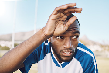 Image showing Tired black man, face and soccer player on outdoor field, playing game or football training with energy and exhausted athlete. Team sport, sweating and fitness, challenge and fatigue with workout