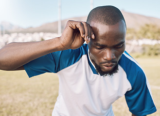 Image showing Black man is tired, face and football player on outdoor field, playing game or soccer training with energy and exhausted athlete. Team sport, sweating and fitness, challenge and fatigue with workout