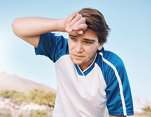 Image showing Man, tired with face and soccer player on outdoor field, playing game or football training with energy and exhausted athlete. Team sport, sweating and fitness, challenge and fatigue with workout