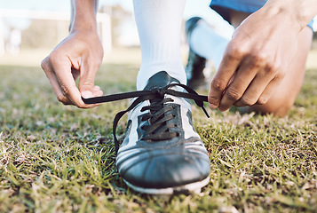 Image showing Sports, soccer field and man tie shoes for game, ready for training, workout and fitness outdoor. Male, guy or athlete tying shoe lace, before practice or exercise for wellness, cardio or competition